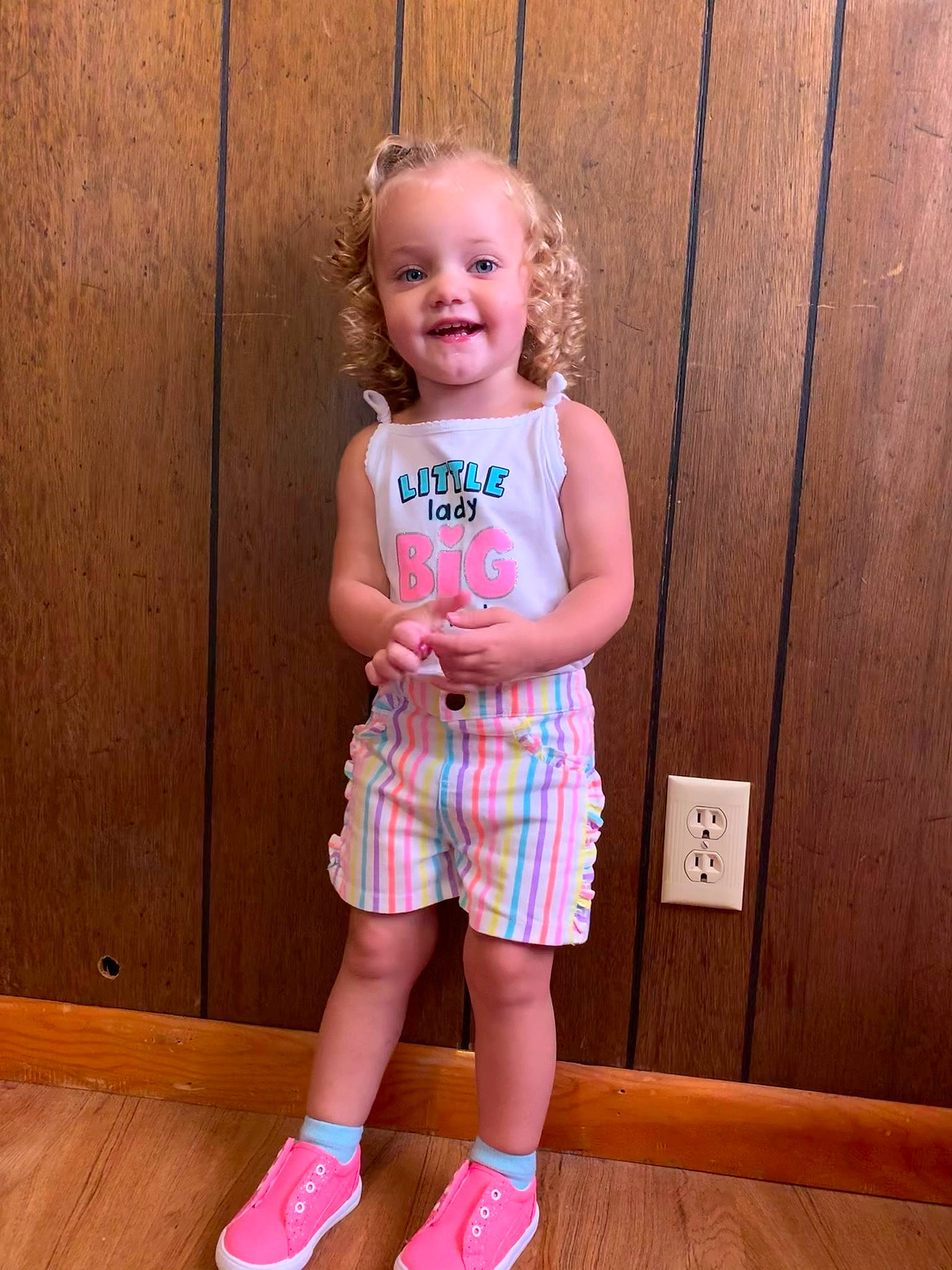 Rowan is registered to the contest to win money with this photo: baby_toddler_clothing, child, dress, face, happy, hardwood, human_leg, joy, knee, magenta, pattern, person, pink, shorts, skin, smile, sock, t_shirt, thigh, toddler