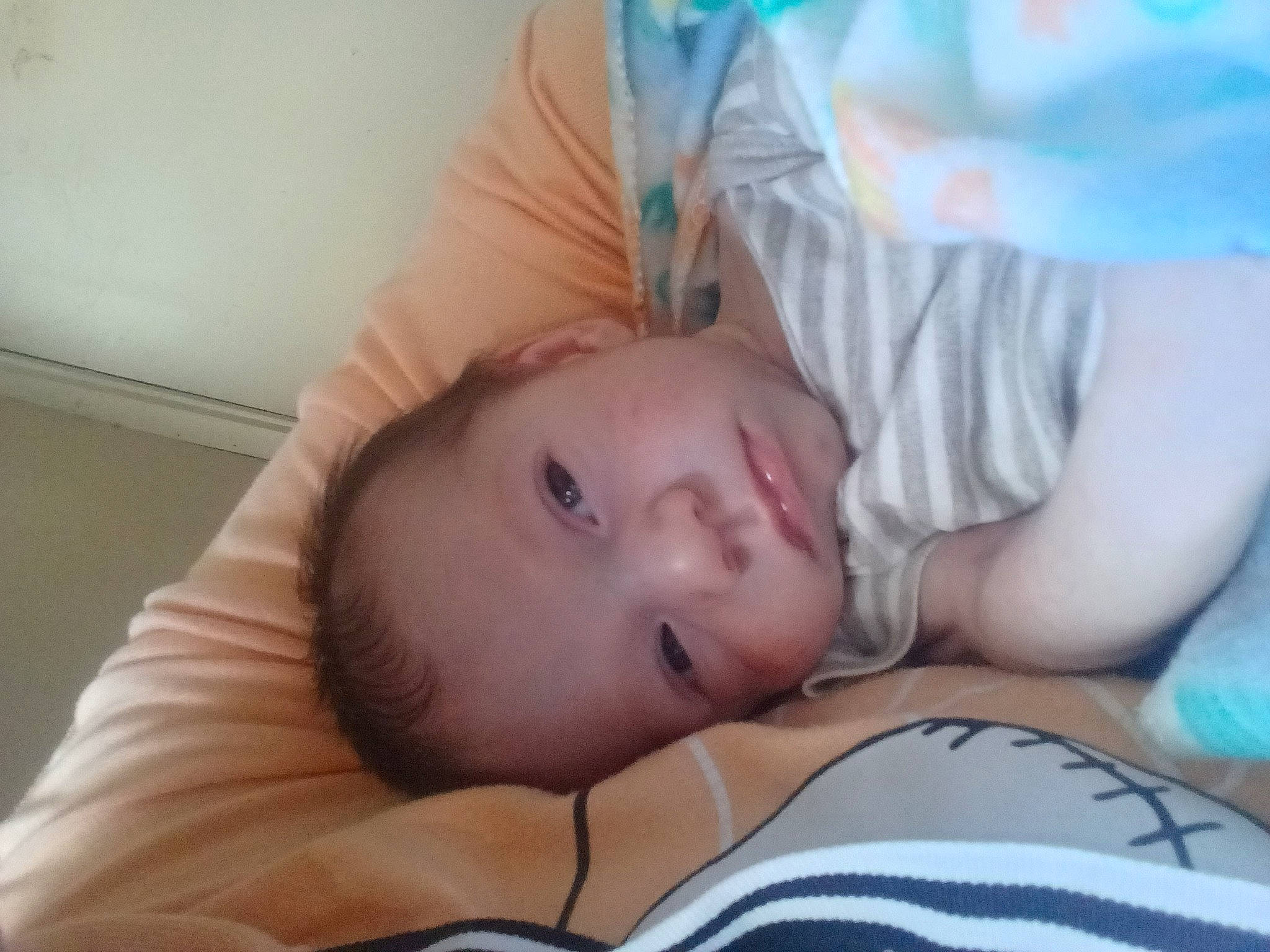 Ezekeiel is registered to the contest to win money with this photo: baby, baby_toddler_clothing, bedtime, cheek, child, comfort, eye, eyelash, linens, nap, nose, pattern, person, portrait_photography, room, sitting, sleep, toddler, wood