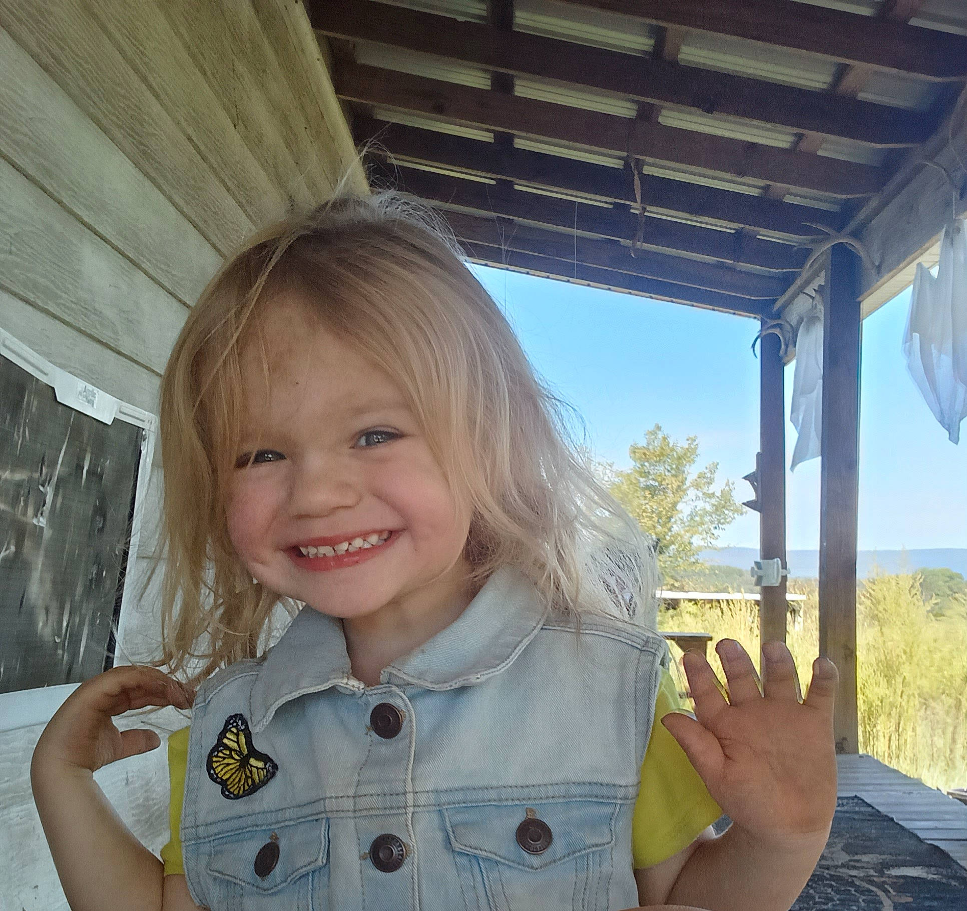 Elizah is registered to the contest to win money with this photo: baby_toddler_clothing, blond, child, finger, fun, gesture, grass, hand, happy, iris, joy, person, plant, shade, skin, sky, sleeve, smile, thumb, toddler