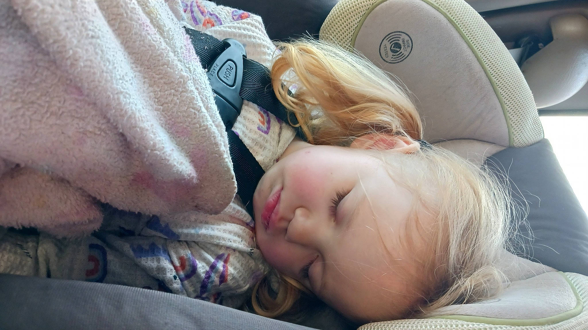 Elizah is registered to the contest to win money with this photo: auto_part, baby, bedtime, car, car_seat, car_seat_cover, child, comfort, family_car, fun, grass, happy, hat, luxury_vehicle, person, skin, steering_wheel, toddler, tree, vehicle_door