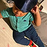 Veyquan is registered to the contest to win money with this photo: child, toddler, portrait, sitting, bed, bedroom, striped_shirt, blue_pants, colorful_socks, cap, hat, fashion, indoors, cozy, playful, serious_expression, looking_down, clothing, textile, photography