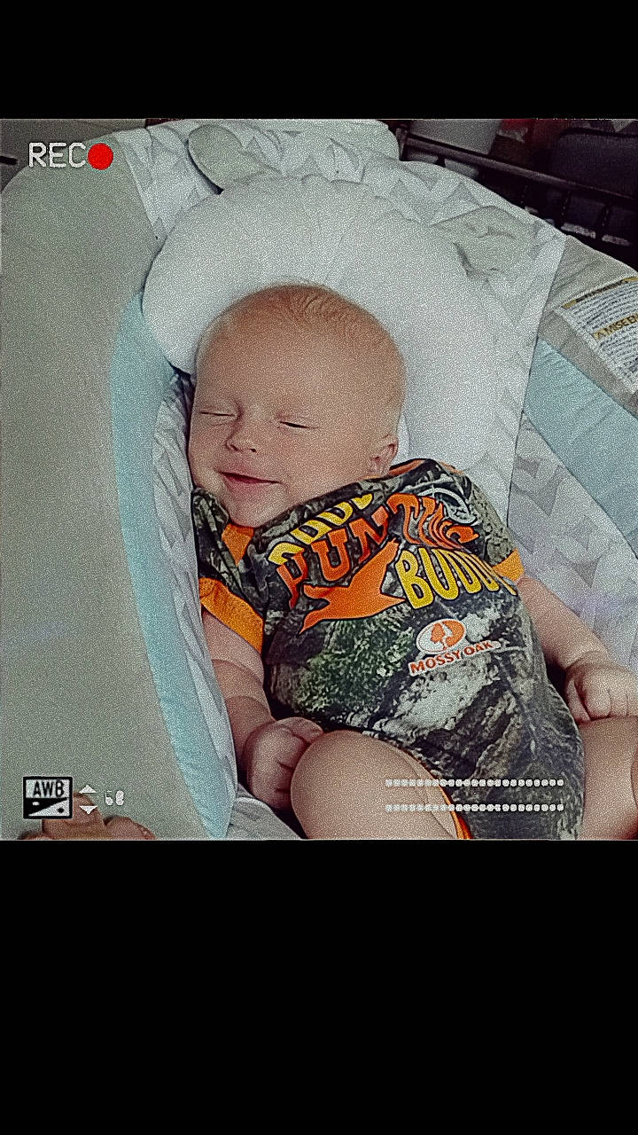 Xzavier is registered to the contest to win money with this photo: abdomen, baby, baby_products, baby_sleeping, baby_toddler_clothing, bedtime, child, comfort, flash_photography, font, happy, human_leg, lap, pattern, person, photo_caption, room, sitting, thigh, toddler