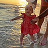 Gradie joined the competition — help win amazing prizes! adult, baby, beach, cap, child, dress, family, happy, headband, holding_hands, ocean, outdoor, sand, shadow, smiling, sunlight, sunset, tattoo, water, waves