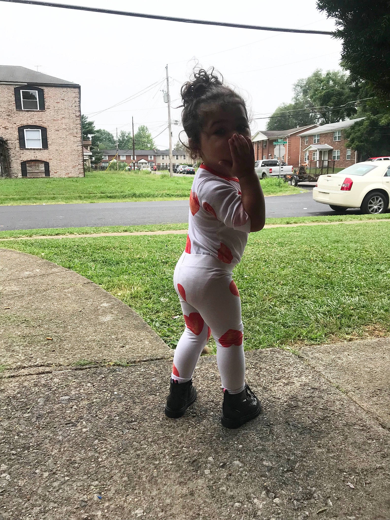 Nemah is registered to the contest to win money with this photo: asphalt, boot, car, child, grass, human_leg, knee, person, plant, recreation, road, road_surface, sky, sneakers, soil, thigh, tire, toddler, tree, under_exposed