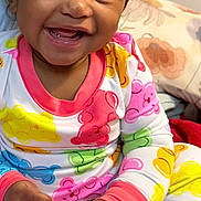 Kali joined the competition — help win amazing prizes! baby, bed, casual, child, colorful_clothing, cozy, cute, face, fun, hands, happy, indoor, pajamas, pillow, playful, portrait, sitting, smiling, toddler, young_child