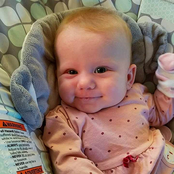 Lydia joined the competition — help win amazing prizes! baby, baby_products, baby_safety, baby_sleeping, baby_toddler_clothing, bib, cheek, child, comfort, facial_expression, happy, head, linens, pattern, person, sitting, skin, sleeve, smile, toddler