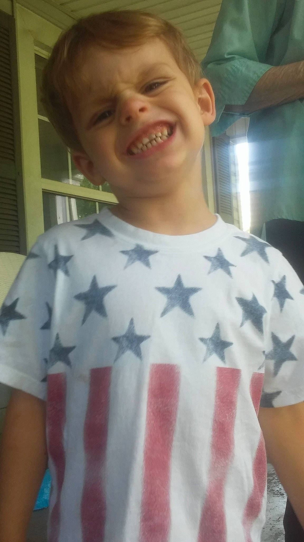 Ryder is registered to the contest to win money with this photo: arm, chest, child, cool, human_body, jaw, joint, mouth, neck, person, shoulder, sleeve, smile, t_shirt, tooth, top