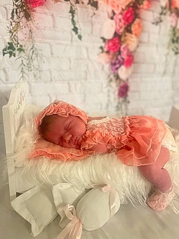 Emberlynn is registered to the contest to win money with this photo: baby, bridal_accessory, bridal_clothing, dress, embellishment, event, flower, gown, hair_accessory, happy, headpiece, human_body, peach, person, petal, pink, plant, rose, textile, vintage_clothing