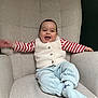 Ethan a rejoint le concours — aidez-le/la à gagner de superbes lots ! baby, child, smiling, happy, sitting, armchair, clothing, vest, striped_shirt, pants, sock, indoor, furniture, cozy, cute, portrait, infant, person, young_child, casual