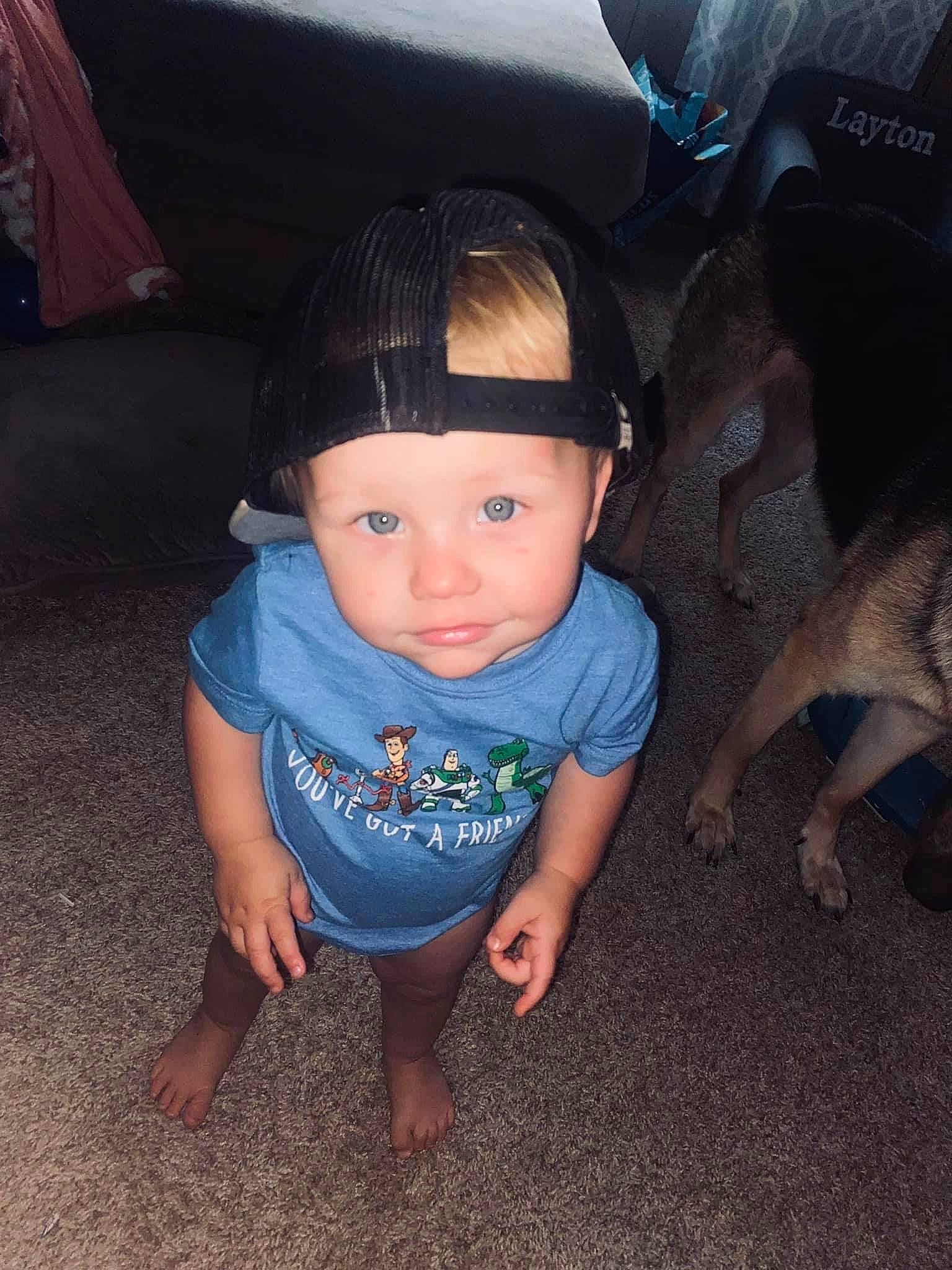 Layton is registered to the contest to win money with this photo: baby, baby_toddler_clothing, baseball_cap, cap, child, companion_dog, cool, dog, electric_blue, fashion_accessory, flash_photography, flooring, fun, grass, joy, person, sitting, soil, t_shirt, toddler