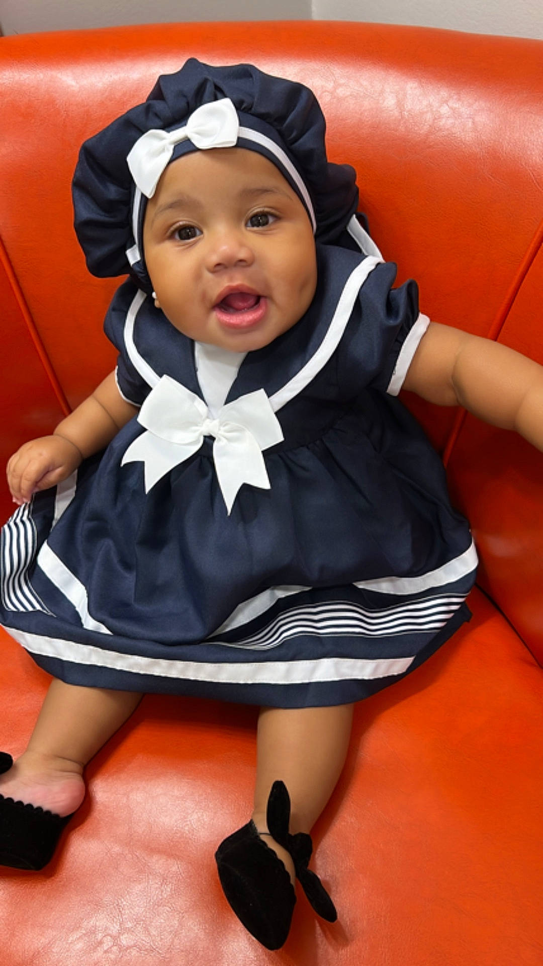 Promise Regans joined the competition — help win amazing prizes! baby, bonnet, cap, clothing, coat, costume, couch, dress, face, footwear, formalwear, furniture, hat, head, hood, person, photography, portrait, shoe, sitting