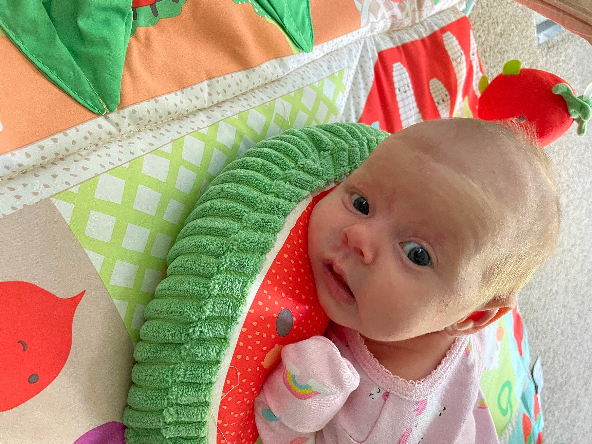 Clementine is registered to the contest to win money with this photo: baby, baby_products, baby_toddler_clothing, carmine, cheek, child, craft, face, fashion_accessory, green, happy, home_accessories, infant_bed, linens, pattern, person, pink, product, rectangle, room