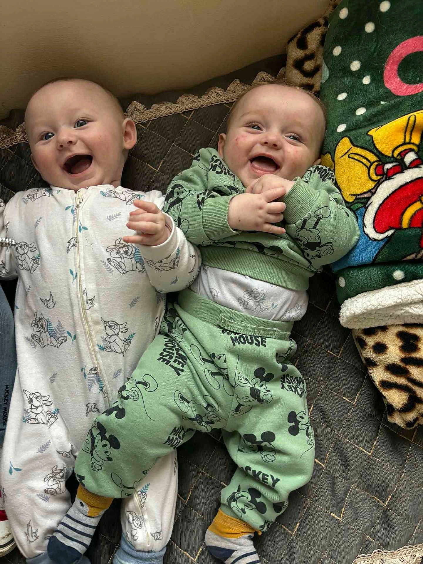 Isaac Et ézio participe au concours pour gagner de l'argent avec cette photo : baby, smiling, pajamas, mickey_mouse, blanket, cartoon, infant, cute, happy, child, bed, sleepwear, portrait, two_children, lying_down, cozy, indoor, playful, patterned_clothing, toddler