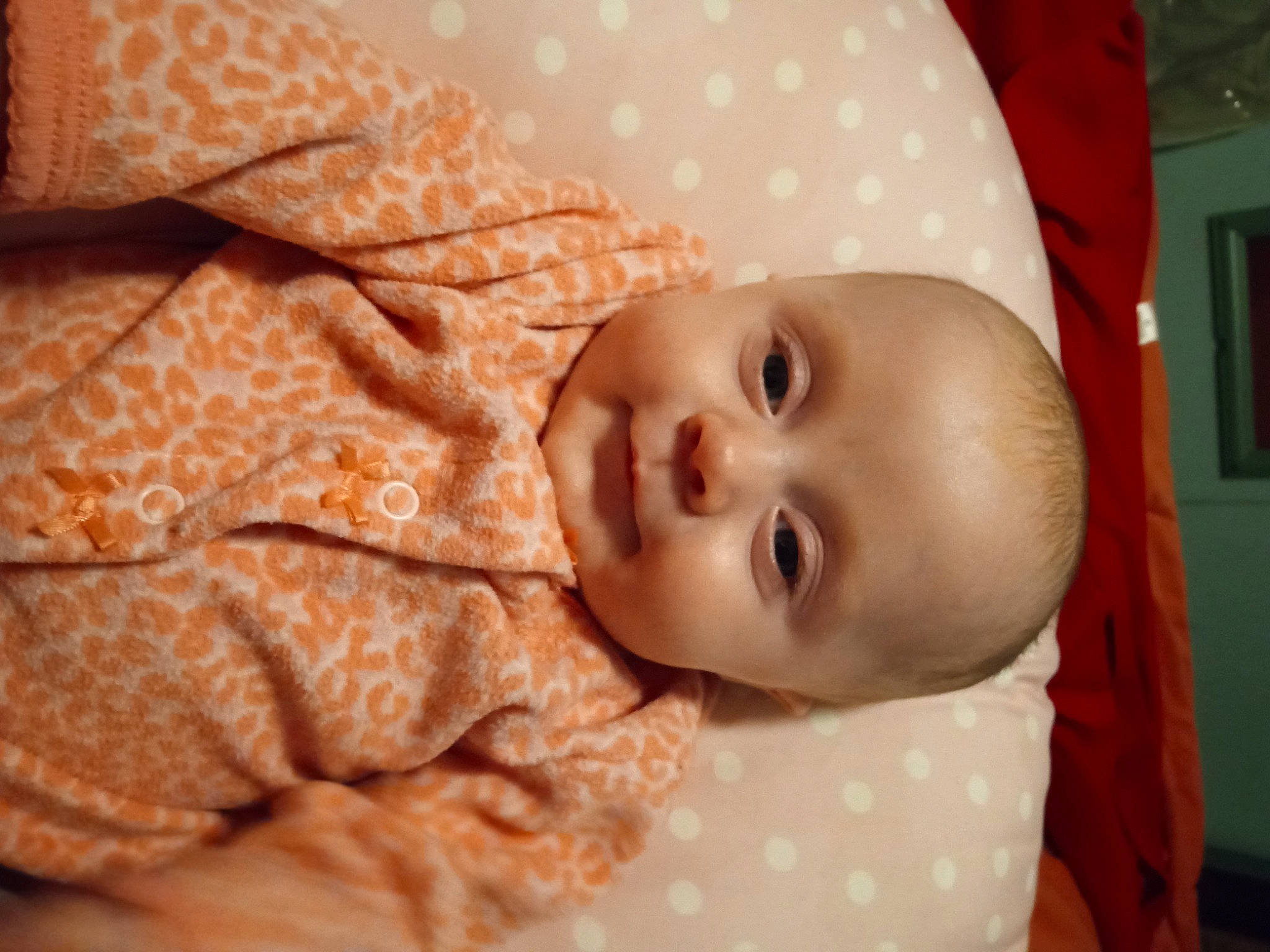 Jaycee is registered to the contest to win money with this photo: baby, baby_products, baby_toddler_clothing, cheek, child, comfort, eye, face, iris, linens, lip, mouth, nose, orange, pattern, person, room, skin, sleeve, toddler