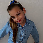 Inaya participe au concours pour gagner de l'argent avec cette photo : child, girl, denim, blue_bow, long_hair, smile, earrings, casual_clothing, standing, posing, wall, indoor, fashion, buttoned_shirt, portrait, youth, happy, person, hair_clip, jeans