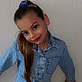 child, girl, denim, blue_bow, long_hair, smile, earrings, casual_clothing, standing, posing, wall, indoor, fashion, buttoned_shirt, portrait, youth, happy, person, hair_clip, jeans