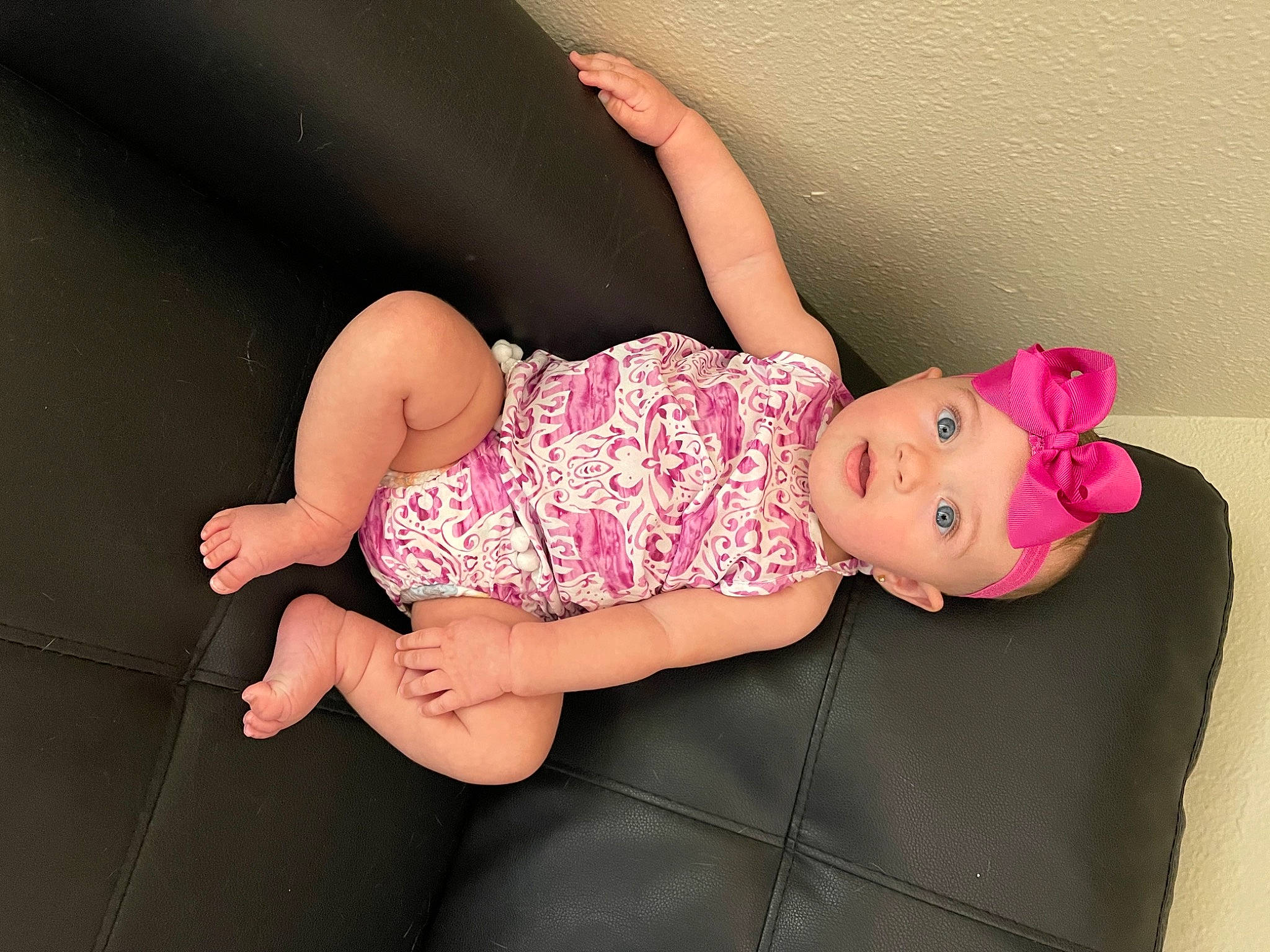 Hailey is registered to the contest to win money with this photo: arm, baby_toddler_clothing, child, comfort, dress, finger, hand, headwear, human_body, human_leg, joint, knee, leg, magenta, pattern, person, pink, skin, sleeve, thigh