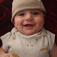 Ernest joined the competition — help win amazing prizes! baby, infant, smiling, beanie, hat, onesie, red_blanket, blanket, closeup, portrait, cute, dimple, big_eyes, cheeks, hand, skin, fabric, cozy, happy, wearing_bracelet