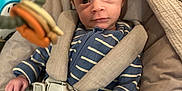 Harry is registered to the contest to win money with this photo: baby, baby_seat, blanket, child, comfort, cozy, cushion, cute, eyes, face, hand, harness, indoor, infant, newborn, onesie, person, portrait, striped_clothing, toy