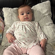 John joined the competition — help win amazing prizes! baby, infant, child, portrait, couch, pillow, plush, soft_toys, clothing, pink, white, pattern, face, eyes, hand, sitting, indoor, leather, cute, young