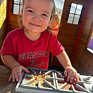 Brooks joined the competition — help win amazing prizes! child, toddler, smiling, portrait, outdoor, playhouse, wooden_cabin, sunlight, toy, sandbox, construction, hands, red_shirt, texas_tech, table, playtime, happy, face, daylight, family_photo