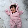 baby, child, snow, pink_snowsuit, sleeping, outdoor, winter, headband, cute, cold_weather, infant, one_person, clothing, footwear, nature, laying_down, face, peaceful, winter_clothes, snowy_background