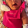 Lillian is registered to the contest to win money with this photo: baby, infant, pink_clothing, mittens, face, sleepy, lying_down, patterned_pants, cute, newborn, child, soft_lighting, indoors, portrait, closeup, expression, skin, head, hand, young_child