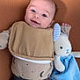 Benjamin is registered to the contest to win money with this photo: baby, infant, smiling, stuffed_toy, bunny, bib, onesie, blue, beige, brown, cute, lying_down, face, child, happy, soft_toy, indoor, texture, clothing, person