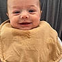 baby, smile, bib, face, person, closeup, infant, holding, clothing, happy, portrait, cute, child, young, skin, head, eyes, expression, warm, indoor