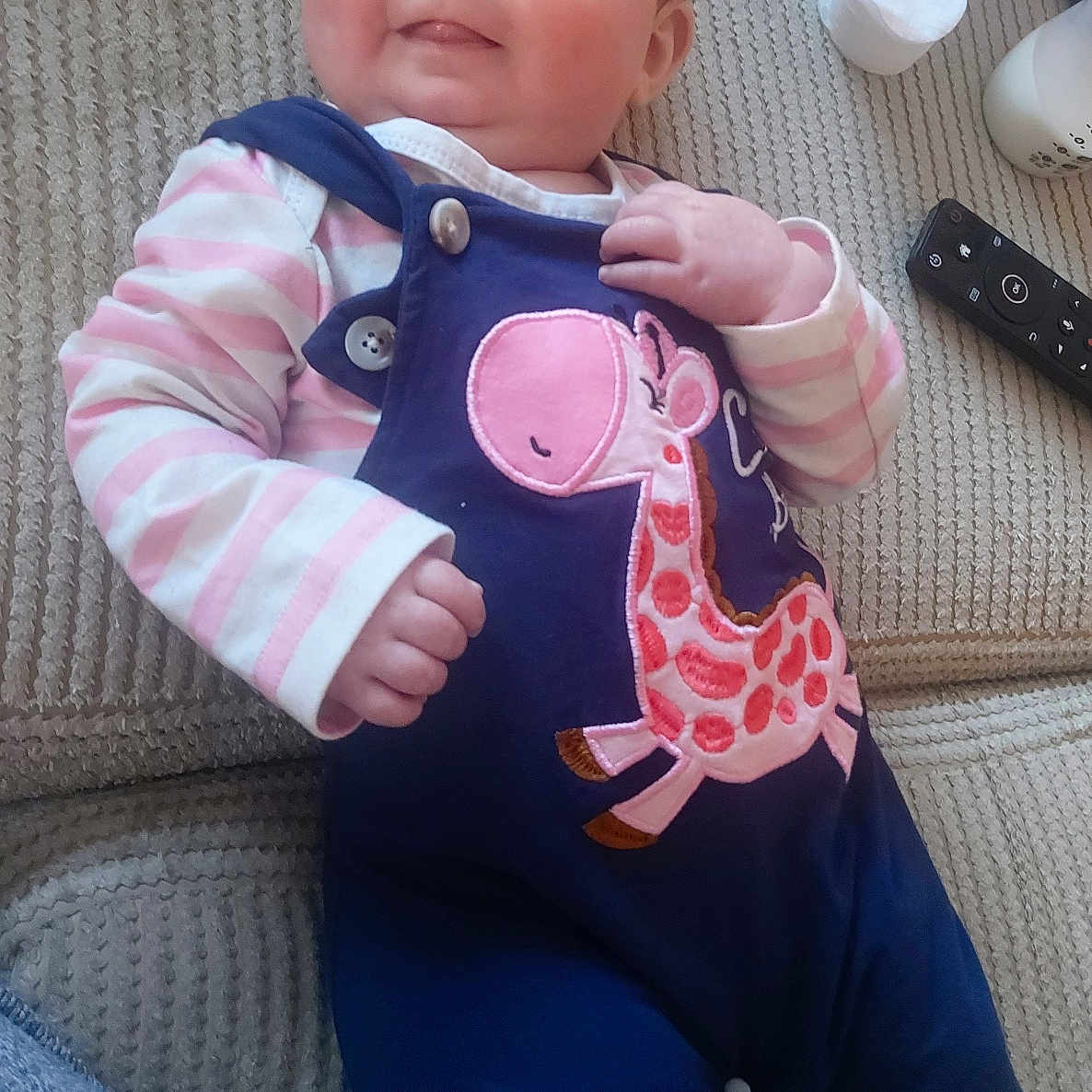 Nevaeh is registered to the contest to win money with this photo: baby, bodypart, clothing, coat, couch, cushion, face, finger, furniture, hand, head, homedecor, jacket, jeans, knitwear, pants, person, photography, portrait, sweater