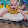 Destiny is registered to the contest to win money with this photo: baby, child, infant, smiling, yellow_outfit, pillow, tummy_time, play_mat, toy, indoor, home, nursery, portrait, face, blue_eyes, sitting, lying_down, happy, colorful, floor