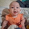 Destiny joined the competition — help win amazing prizes! baby, infant, child, smiling, portrait, indoor, bed, bedding, orange_outfit, clothing, blue_eyes, plush_toy, toy, bedroom, cushion, sitting, happy, face, people, photography