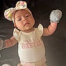 apparel, baby, bow, child, clothing, cute, expression, fabric, floral, headband, infant, lying_down, mama_bestie, mittens, onesie, person, pink, portrait, sleepwear, soft_light