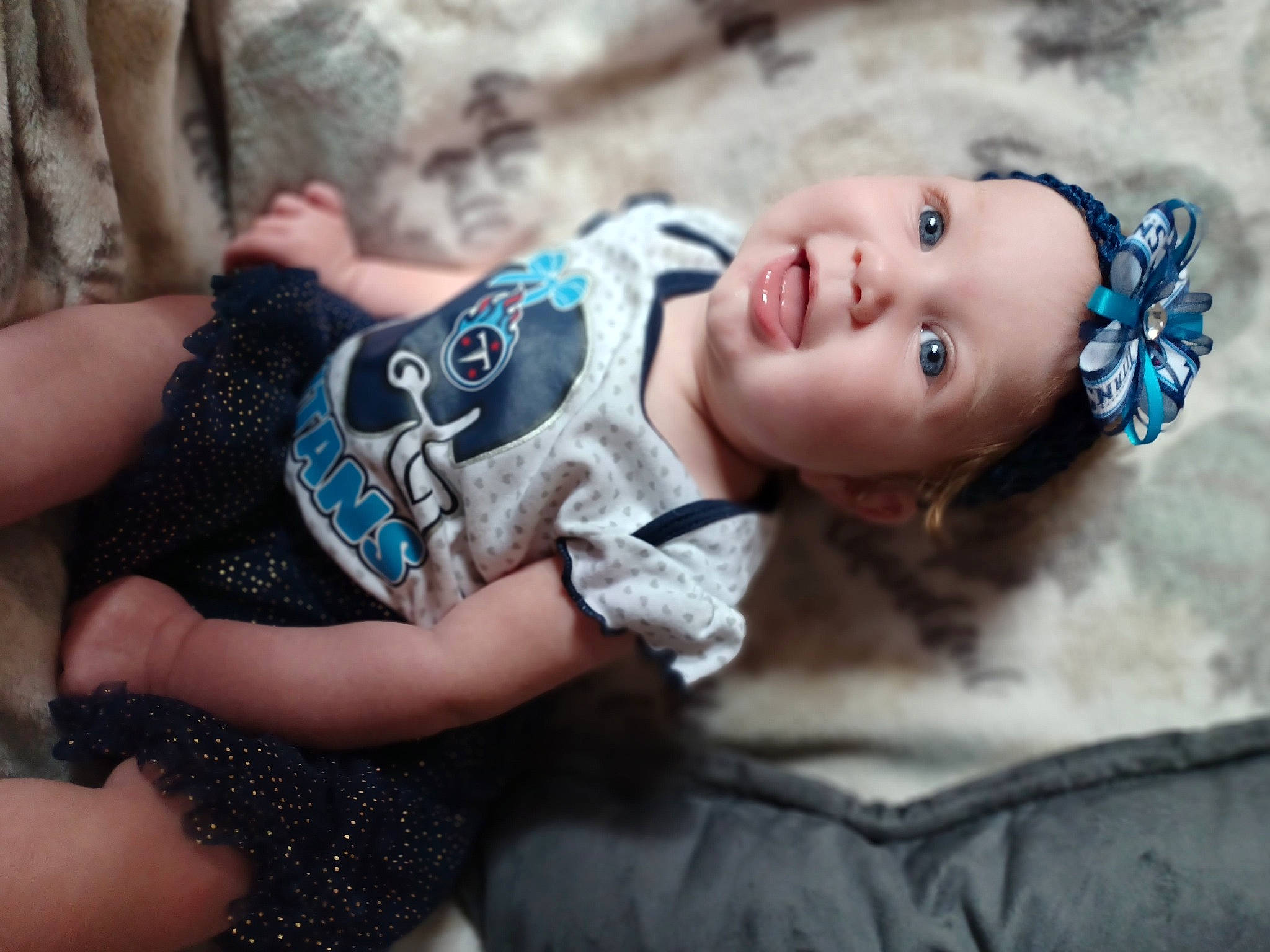 Delaney is registered to the contest to win money with this photo: baby, baby_toddler_clothing, child, eye, fashion_accessory, flash_photography, fun, fur, grass, hair_accessory, happy, headwear, iris, pattern, person, personal_protective_equipment, portrait_photography, sitting, skin, smile