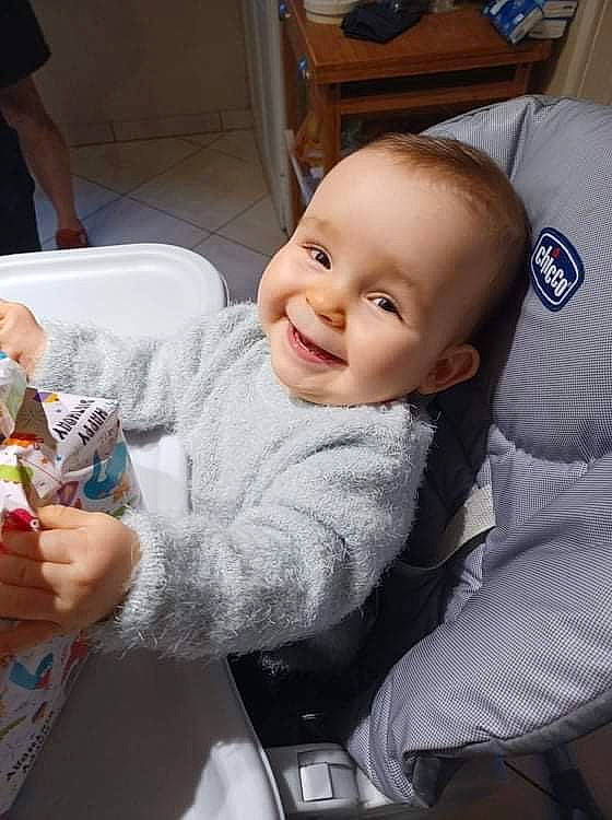 Naima a rejoint le concours — aidez-le/la à gagner de superbes lots ! baby, baby_products, baby_toddler_clothing, car_seat, chair, cheek, child, comfort, comfort_food, fun, happy, iris, joy, mouth, person, room, sitting, skin, smile, tableware