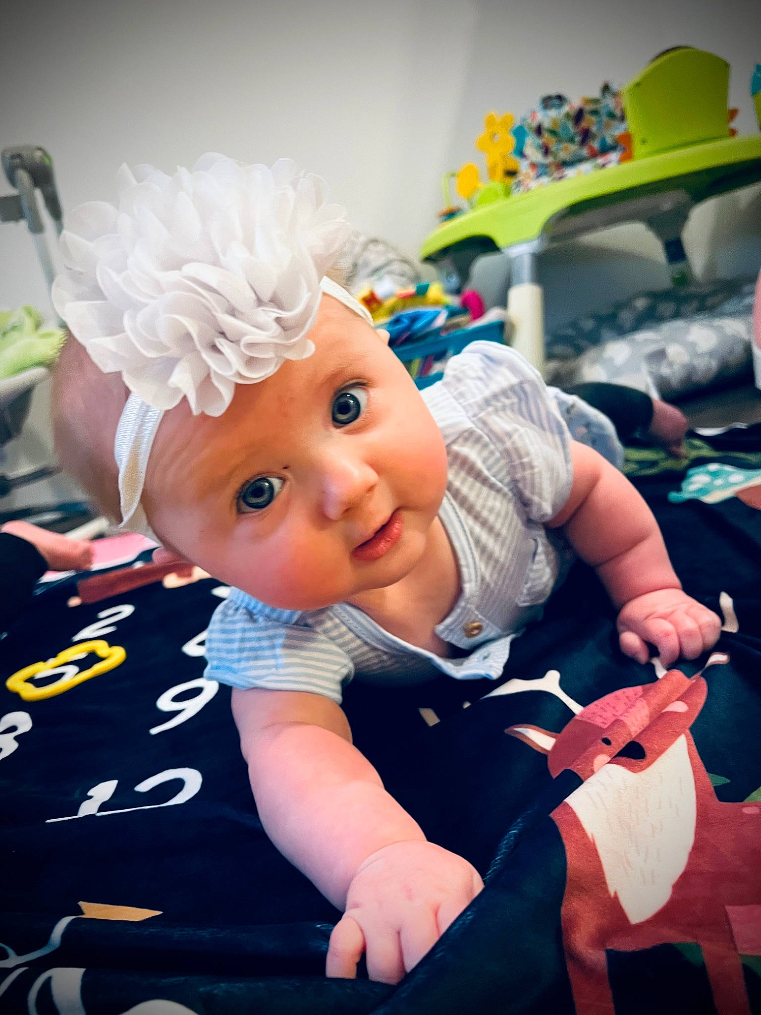 Faith is registered to the contest to win money with this photo: baby, child, event, fictional_character, figurine, fun, gesture, happy, hat, headwear, lap, party_supply, person, pink, play, recreation, room, sitting, stuffed_toy, toddler