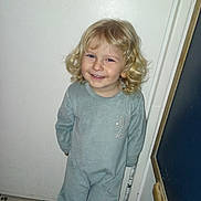 Ethan participe au concours pour gagner de l'argent avec cette photo : child, toddler, blond_hair, curly_hair, pajamas, smile, standing, indoor, door, tile_floor, cute, young_child, person, portrait, happy, casual, light_blue, sleepwear, home, small_child