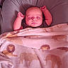 Wyatt joined the competition — help win amazing prizes! baby, infant, sleeping, portrait, face, arms_raised, blanket, lion_pattern, pink, cozy, nursery, bassinet, bed, indoors, resting, peaceful, closed_eyes, baby_cup, soft_lighting, cute