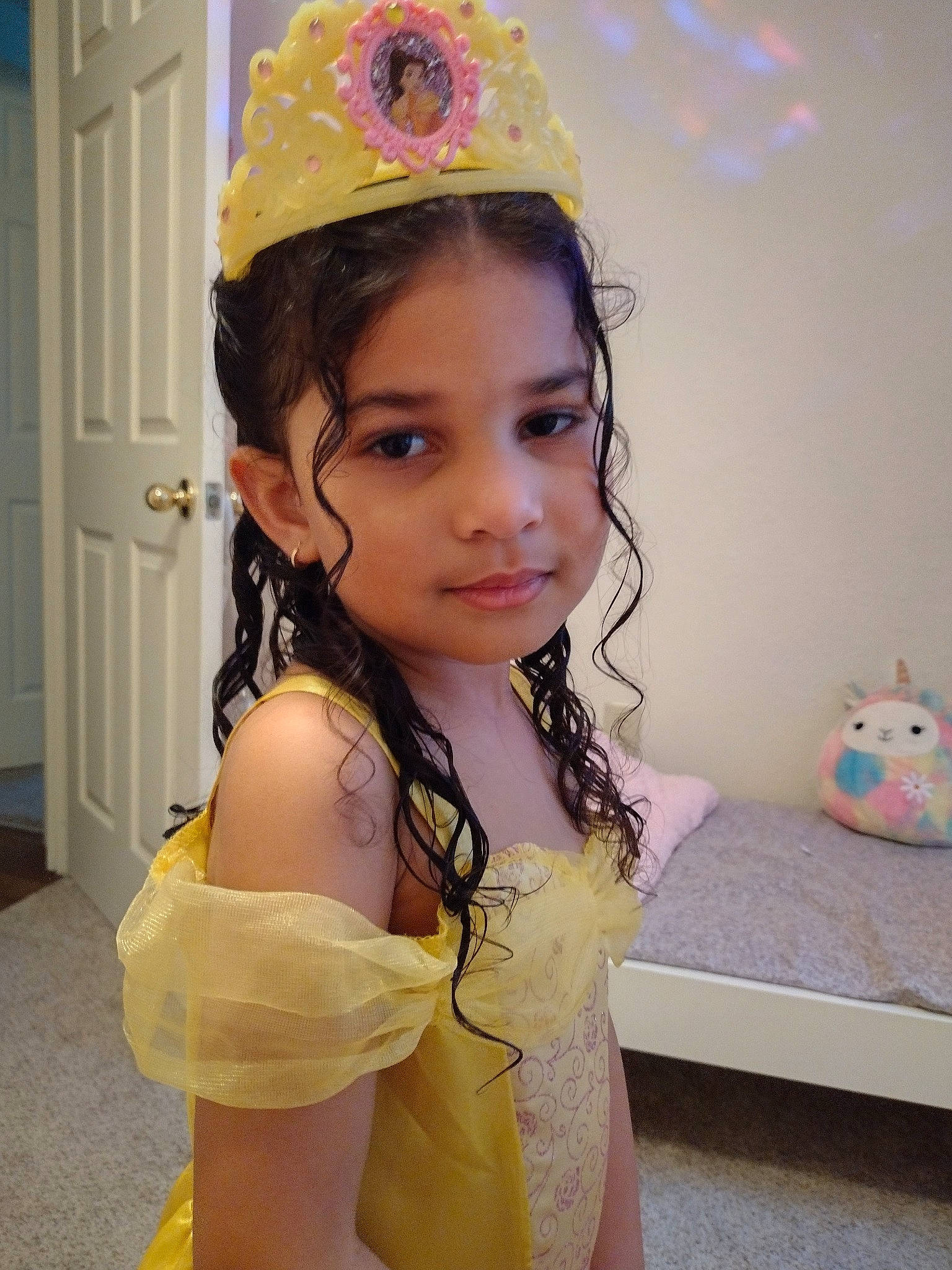 Leila is registered to the contest to win money with this photo: black_hair, clothing, costume_hat, door, eye, eyelash, fashion_design, fun, hair, hair_accessory, happy, head, headband, headpiece, jewellery, long_hair, neck, person, thigh, toddler