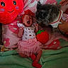 Lorelei is registered to the contest to win money with this photo: baby, infant, dog, pet, plush_toy, blanket, pink, red, tutu, headband, yawning, cute, cozy, fluffy, animal, resting, soft_toy, hand, indoor, decor
