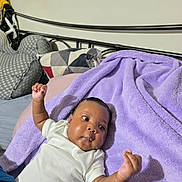 Italy joined the competition — help win amazing prizes! baby, infant, bed, blanket, purple_blanket, white_shirt, raised_arms, curious_expression, indoors, pillow, headboard, sleepwear, soft_texture, young_child, human, skin, face, lying_down, resting, cozy