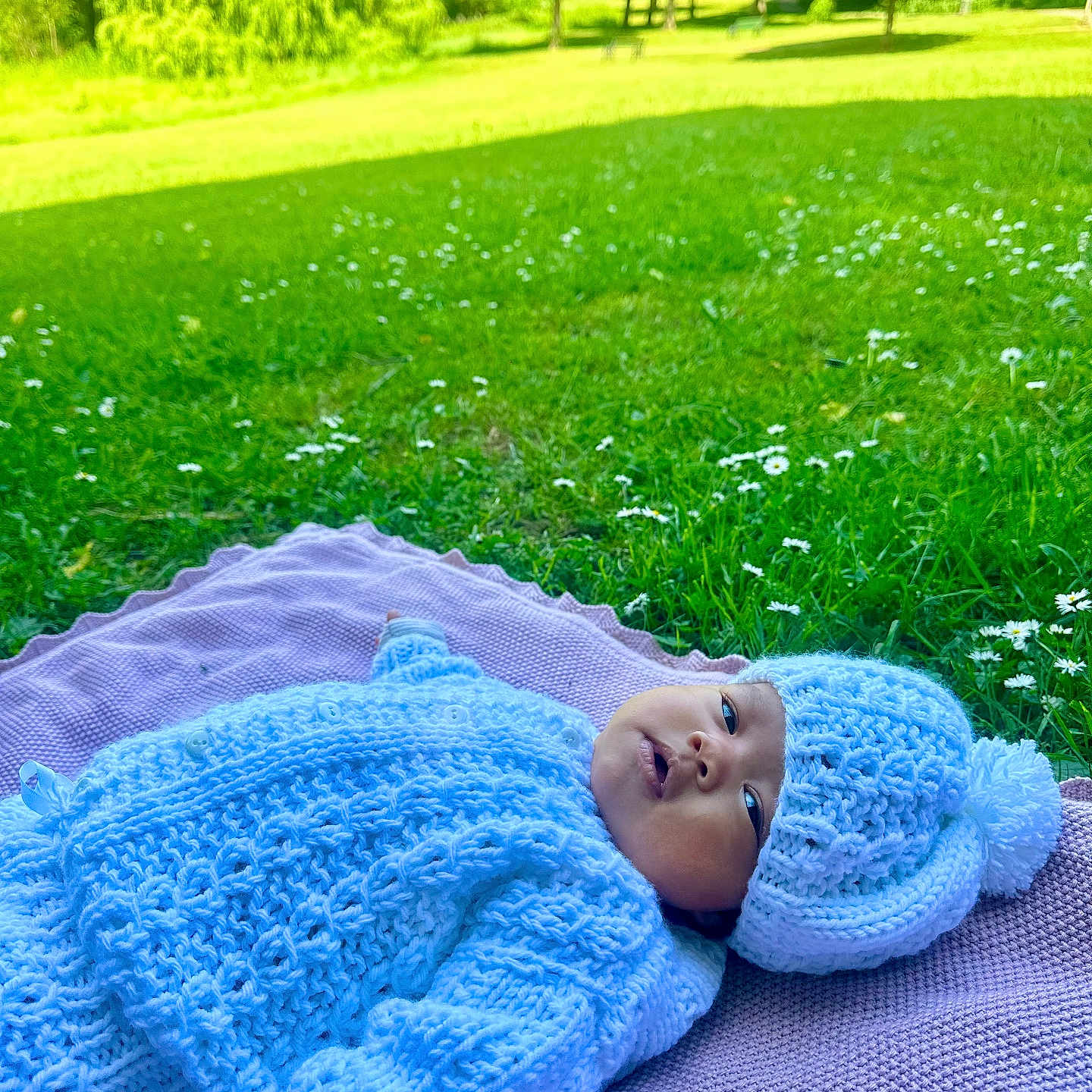 Isabella joined the competition — help win amazing prizes! baby, blanket, child, cute, flowers, grass, greenery, hat, infant, knitted_clothing, lying_down, nature, outdoor, park, peaceful, portrait, relaxing, soft_texture, sunlight, warm_clothing