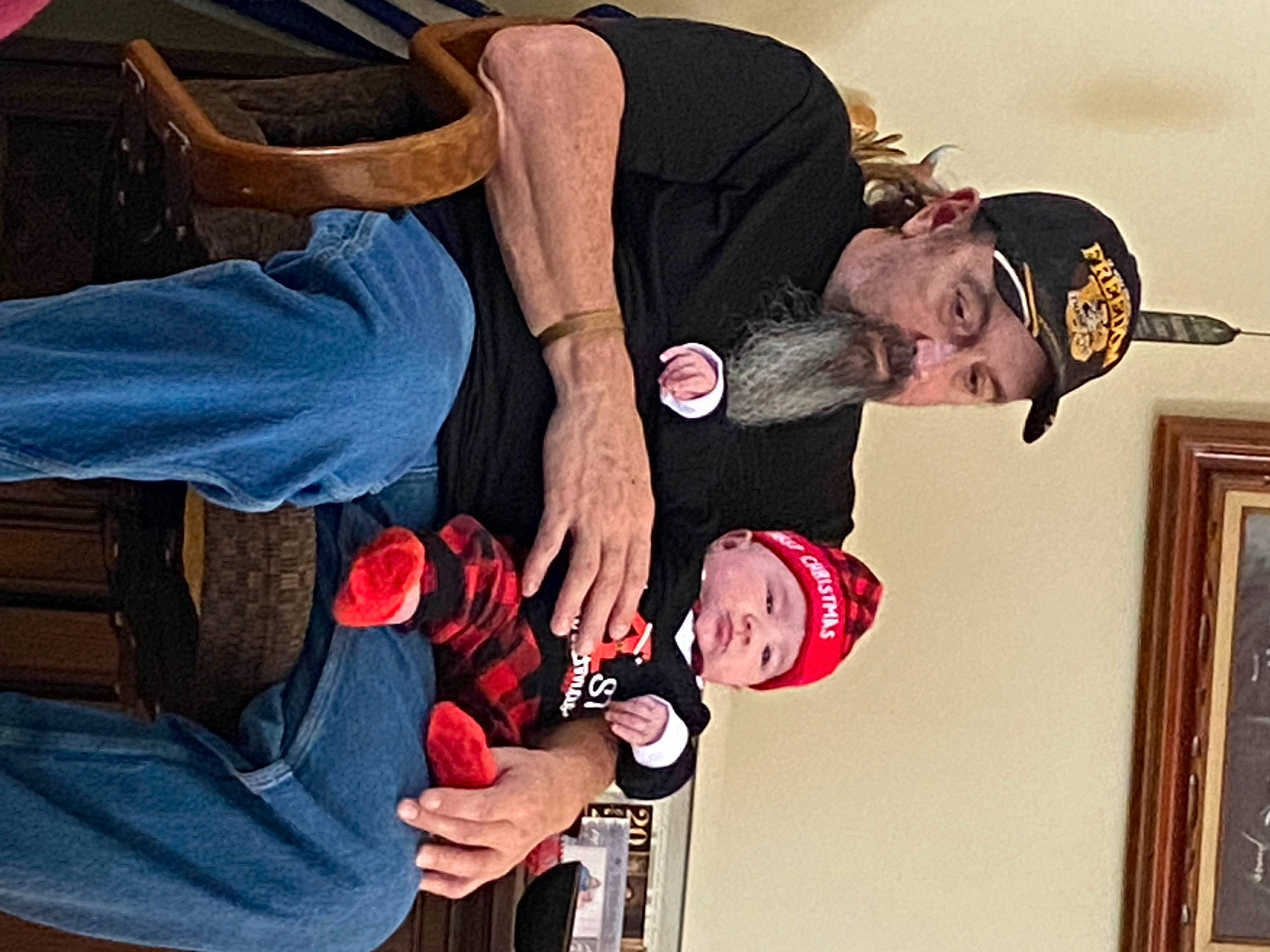 Killian is registered to the contest to win money with this photo: arm, baby, carmine, comfort, elbow, event, fun, gesture, happy, headwear, human, person, picture_frame, room, wrist