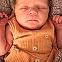 architecture, baby, blanket, bodypart, clothing, cushion, face, finger, frown, glove, hand, head, homedecor, newborn, person, photography, portrait, quilt, sad, sleeping