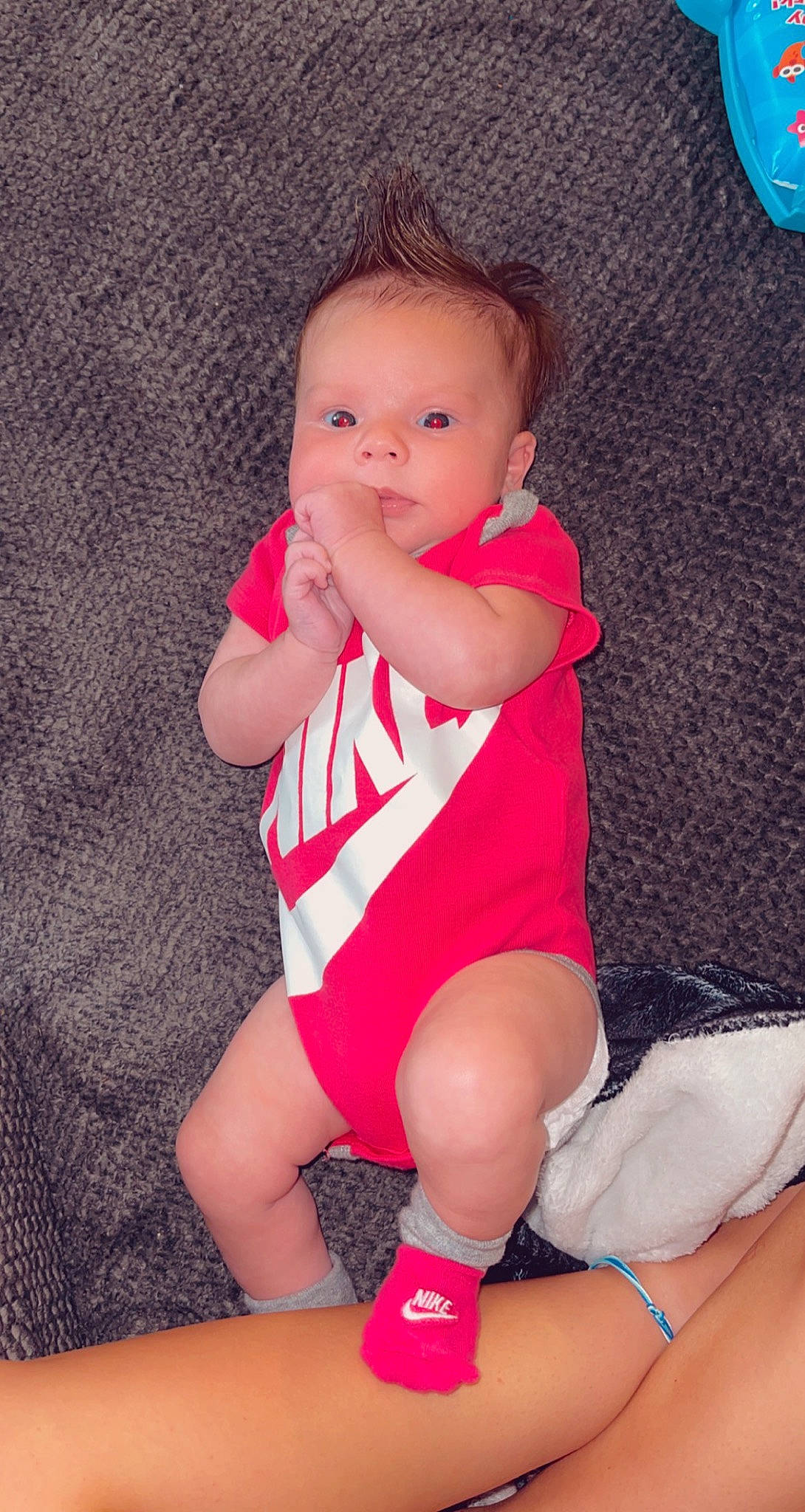 Laylah is registered to the contest to win money with this photo: baby, baby_toddler_clothing, cheek, comfort, eye, face, finger, human_body, joint, knee, leg, mammal, mouth, person, pink, skin, sleeve, sock, textile, thigh