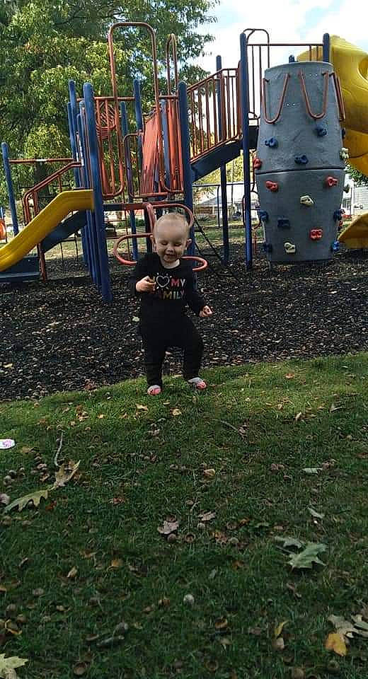 Katerina is registered to the contest to win money with this photo: backyard, child, city, fun, grass, human_settlement, joy, lawn, leaf, leisure, outdoor_play_equipment, park, person, plant, play, playground, playground_slide, public_space, recreation, toddler