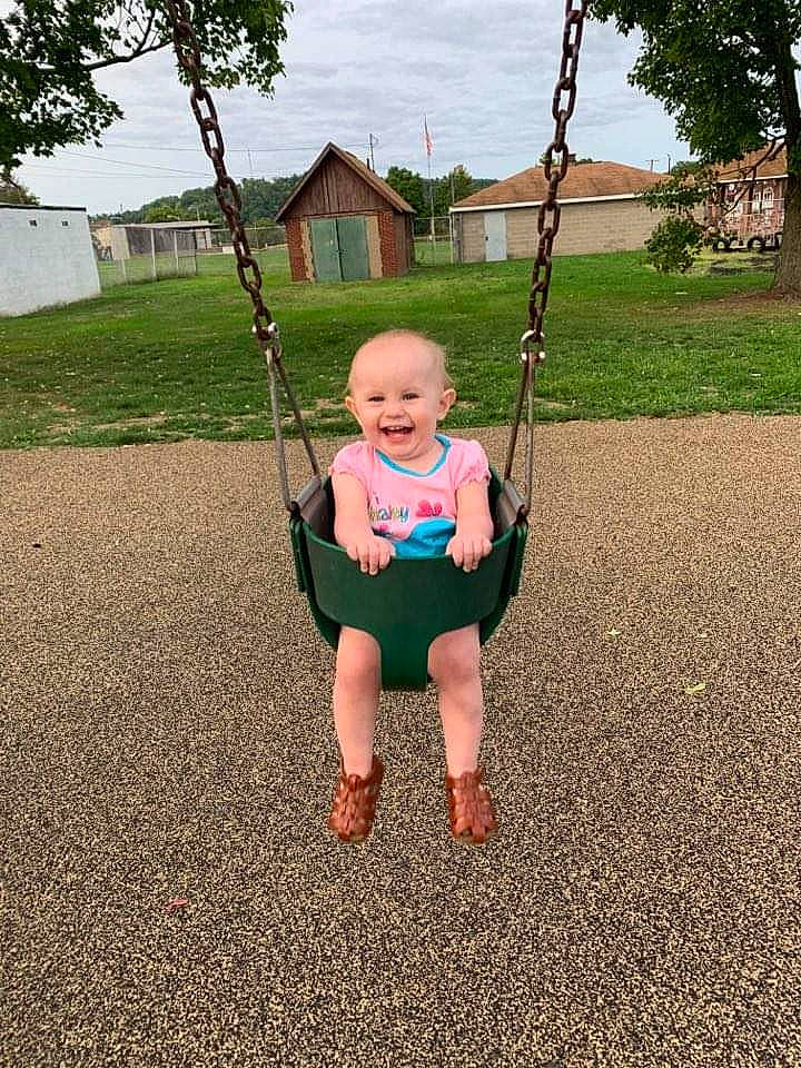 Katerina joined the competition — help win amazing prizes! child, fun, joy, outdoor_play_equipment, person, plant, play, playground, public_space, recreation, smile, swing, toddler, tree