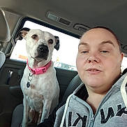 Sasha joined the competition — help win amazing prizes! dog, person, selfie, car_interior, backseat, window, pink_collar, collar, white_dog, pet, hoodie, piercing, nose_ring, seat, portrait, face, animal_face, human_face, casual, leisure