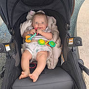 Micah joined the competition — help win amazing prizes! baby, stroller, toy, blanket, smile, infant, outdoor, foot, clothing, person, seat, play, happy, child, relax, cute, comfort, fabric, head, hand