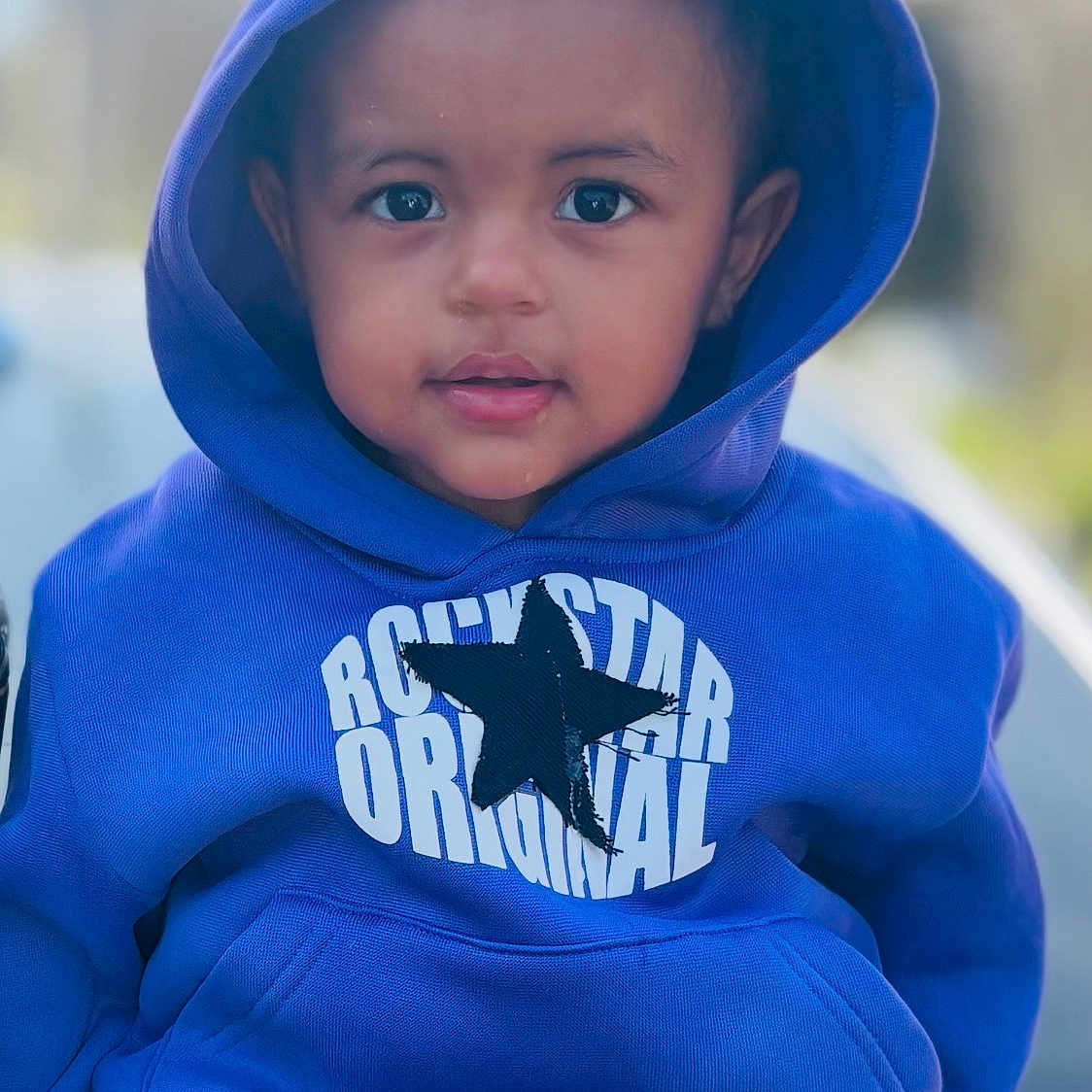 Azlen joined the competition — help win amazing prizes! toddler, child, hoodie, blue_clothing, star_logo, outdoor, portrait, cute, face, young_child, fashion, casual_wear, sitting, person, smiling, closeup, baby, headwear, jacket, leisure